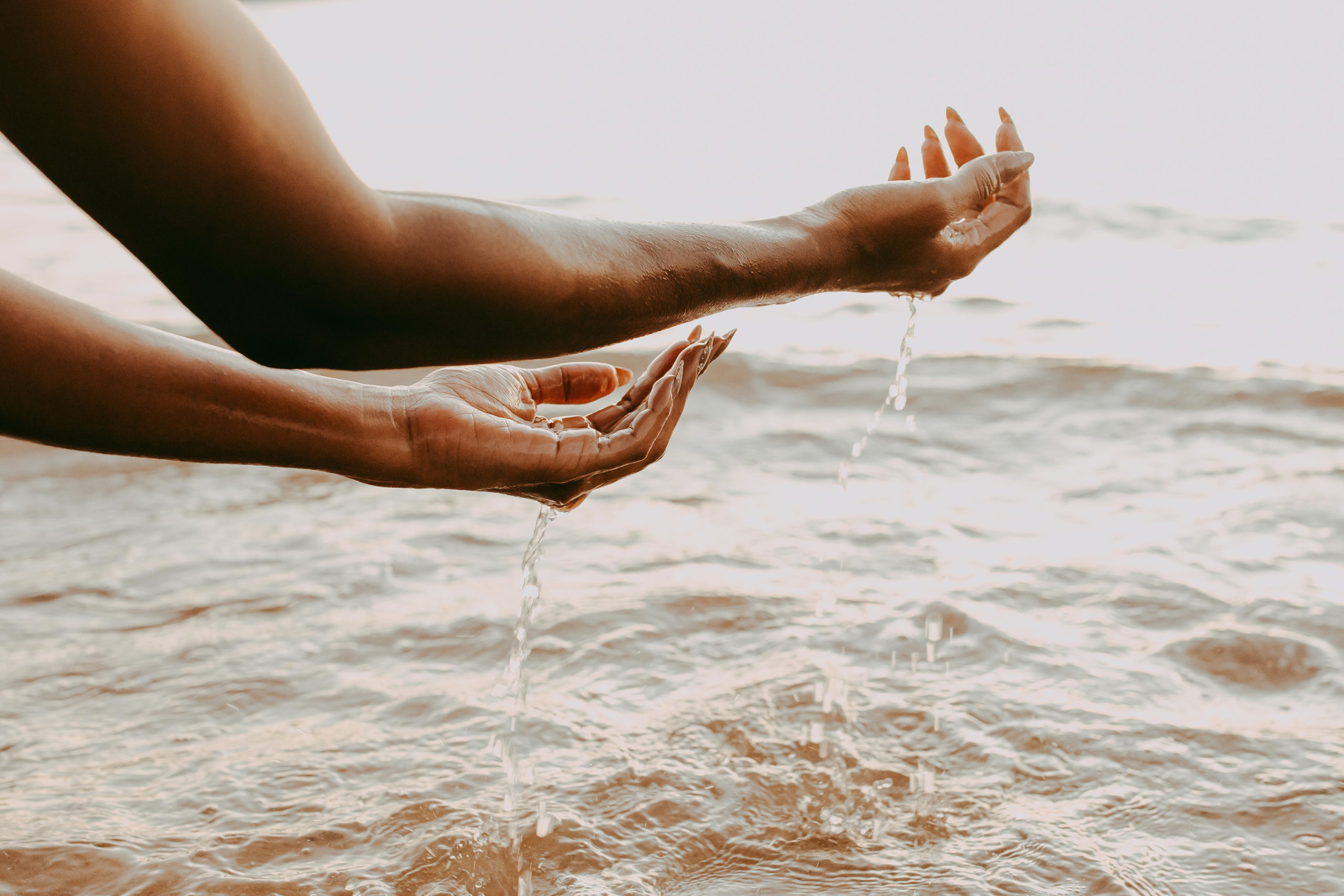 Spiritual Awakening meaning displayed as female hands over water